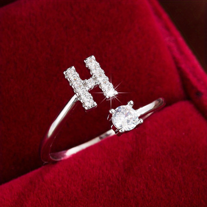 Adjustable Copper Ring With Four-claw Round Zirconia, Featuring The 26 English Letters Of Fashion Trend.