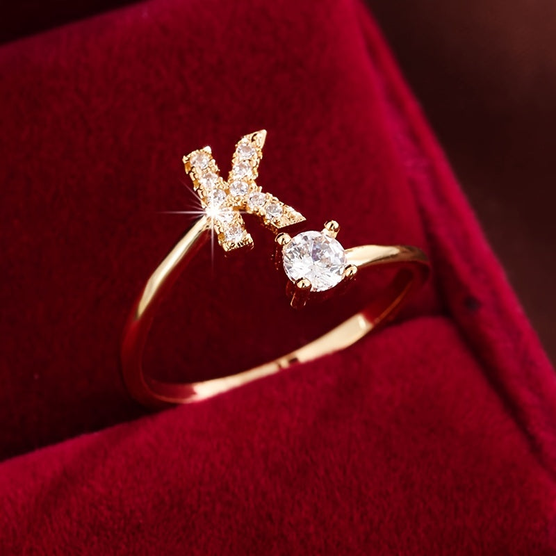 Adjustable Copper Ring With Four-claw Round Zirconia, Featuring The 26 English Letters Of Fashion Trend.