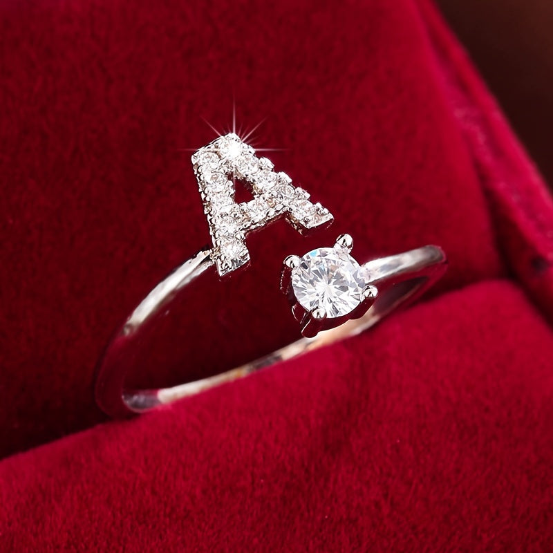 Adjustable Copper Ring With Four-claw Round Zirconia, Featuring The 26 English Letters Of Fashion Trend.