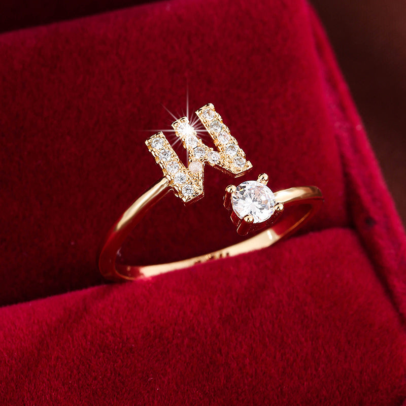Adjustable Copper Ring With Four-claw Round Zirconia, Featuring The 26 English Letters Of Fashion Trend.